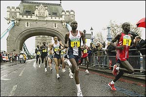 The men's frontrunners keep up the pace as they pass Tower Bridge