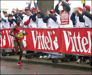 Women's leader Margaret Okayo is cheered on her way to victory,