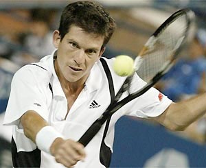 Tim Henman concentrates on a good connection as he returns to Dominik Hrbaty of Slovakia