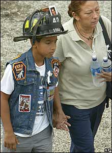 A youngster wears a firefighter's helmet at Ground Zero