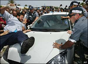 Protesters leap on the car of Mordechai Vanunu