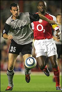 PSV's Gerald Sibon (left) holds off Arsenal's Patrick Vieira