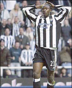 Shoala Ameobi looks disappointed with his hands on his head