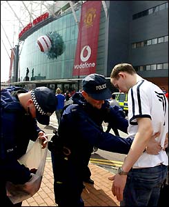 Fans are searched by police outside Old Trafford