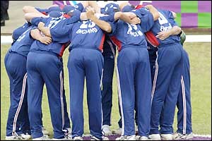 England players form a huddle in the field 