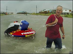 A man in Alabama wades through flood water on his way to a shelter