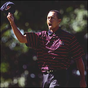 Woods celebrates a birdie putt
