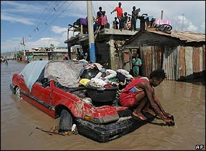 Residents of Gonaives taking refuge on roof tops to avoid the flood waters
