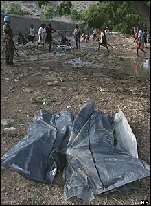 The bodies of two people killed in the flooding lay outside the UN office in Gonaives 