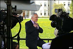 Irish PM Bertie Ahern adjusts his tie before a round of media interviews