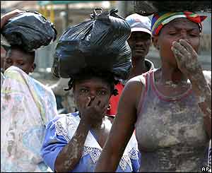 People cover their noses in Gonaives.