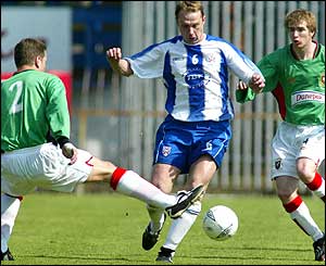 Coleraine's Stephen Beatty gets the better of Glentoran's Mark Glendinning