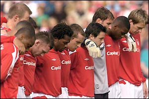 The players and whole stadium observe a minute's silence before kick-off