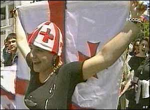 A demonstrator carries Georgia's red-and-white Georgian flag during a protest rally in Batumi