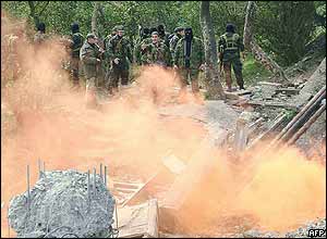 Ajarian militias guard a destroyed bridge linking the province with the rest of Georgia