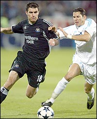 Newcastle's Aaron Hughes (left) battles with Marseille's Camel Meriem