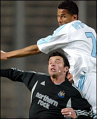 Gary Speed and Marseille's Sylvain NDiaye jump to head the ball