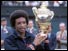Arthur Ashe holds up Wimbledon trophy