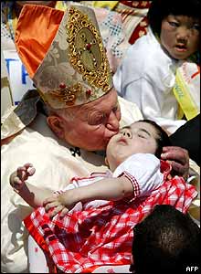 Pope kisses small child