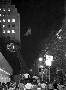 Reeve seen flying through the air attached to a wire and large crane