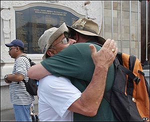 Parents of those who died in the Bali bombing hug each other in front of the memorial