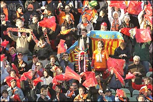 Valencia fans inside the stadium make sure their presence is seen as well as heard as the game gets underway