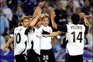 Valencia's delighted players celebrate a 2-0 win that ensures a Uefa cup and Spanish league double