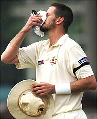Michael Kasprowicz struggles in the heat
