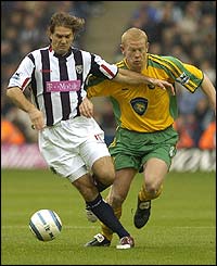 Albion's Andy Johnson holds off Gary Holt 