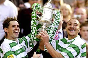 Celtic's Larsson and captain Jackie McNamara lift the cup