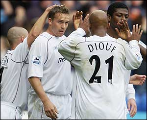 Kevin Davies is congratulated after heading
