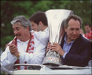 Liverpool chairman David Moores and manager Gerard Houllier hold the Uefa Cup on an open top bus parade
