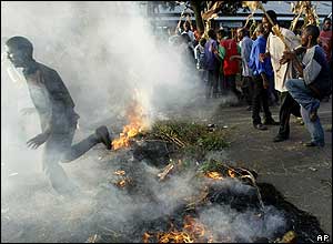 Opposition supporters man a burning barricade