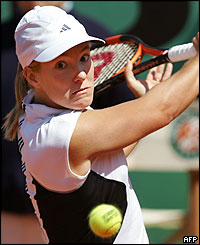 Belgian Justine Henin-Hardenne hits a forehand to France's Sandrine Testud