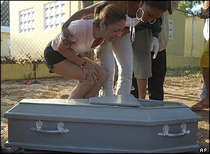 A woman mourns over the body of a relative killed in the floods in Jimani
