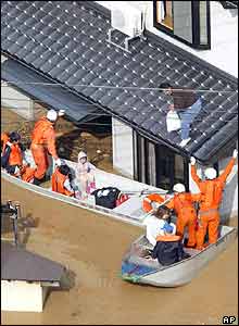 Isolated residents in Toyooka, western Japan are rescued by firefighters Thursday, Oct. 21, 2004. 