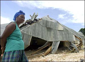Woman stands by remains of church in Fonds Verettes