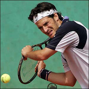 Galo Blanco is forced into a defensive stroke