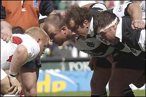 A young England front row prepare to engage with the Barbarians scrum