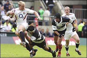 England centre Jamie Noon tries to escape a tackle