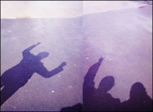 People's shadows on a pavement