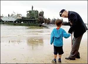 Cyril Ager, 79, a Royal Engineer in the war talks to four-year-old Michael Sheehan from Maidenhead, as they watch the Army's 17 Port and Maritime Regiment ramps boats dock. 