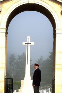 A veteran looks on in remembrance at the Ranville cemetery