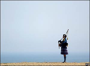 A lone bagpiper plays a lament overlooking Juno Beach in Courseulles-sur-Mer