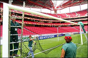 Workers install goalnets at the Estadion Da Luz which hosts the Euro 2004 final on 4 July and England's opening game against France