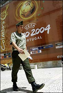 A soldier passes Coimbra Stadium