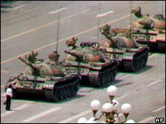 An unidentified man attempts to block tanks entering the square