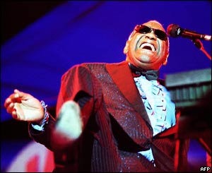 Ray Charles sings, dressed in a red DJ