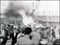 Spectators fleeing from the fire caused by the crash