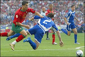 Cristiano Ronaldo trips Greece's Yourkas Seitaridis